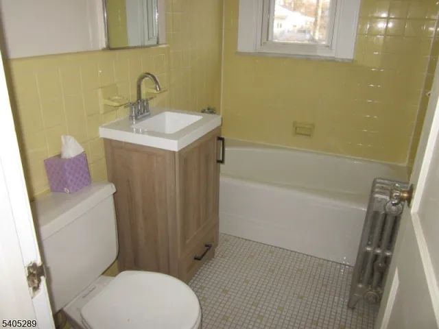 a white toilet sitting next to a bathroom sink