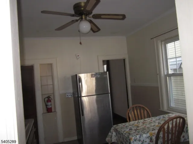 a metallic refrigerator freezer sitting in a kitchen
