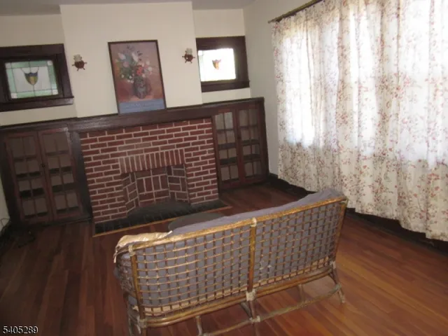 a view of a hallway with wooden floor and stairs