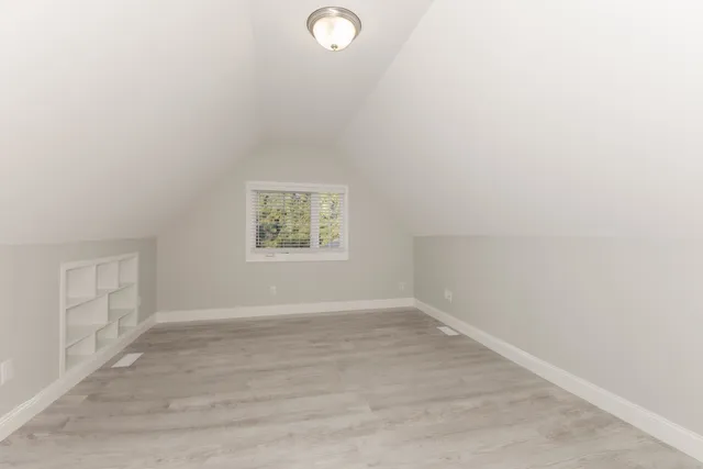 an empty room with a empty space and windows