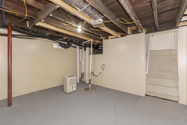 a view of empty room with refrigerator