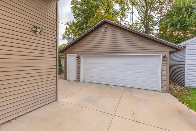 a view of a patio with table and chairs and wooden fence