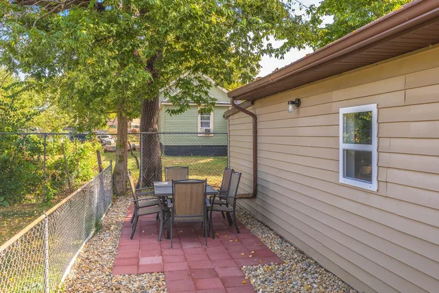 a view of a patio with table and chairs with wooden floor and plants