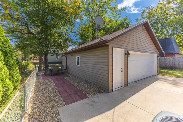an aerial view of a house with a yard and trees
