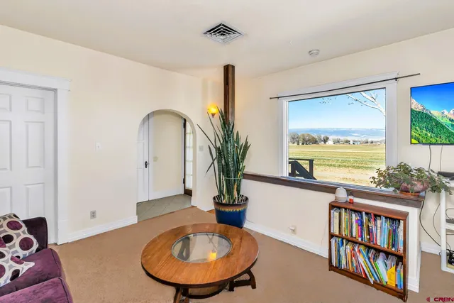 a view of a livingroom with furniture window and wooden floor