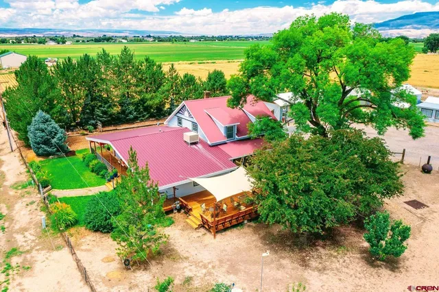an aerial view of a house with garden space and street view