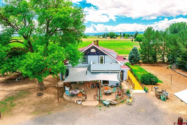 a view of backyard with swimming pool and outdoor seating