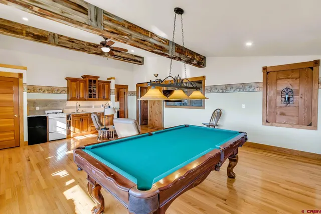 a room with pool table and windows