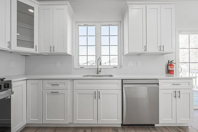 a kitchen with white cabinets and white appliances