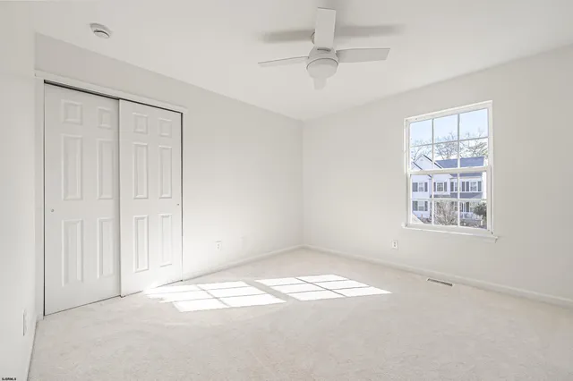 an empty room with a empty space and windows