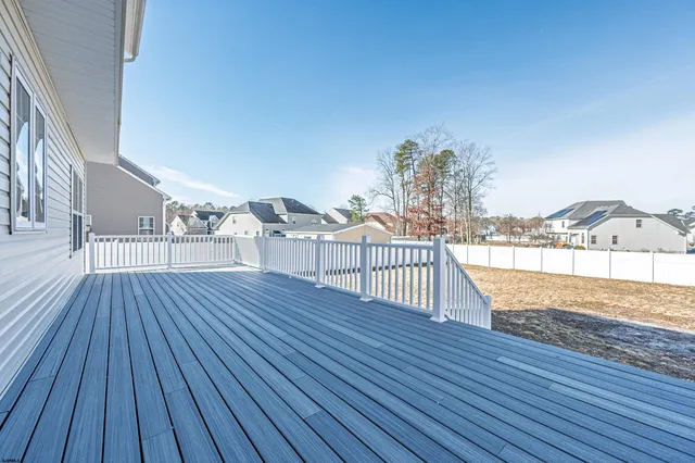 a view of a house with wooden fence