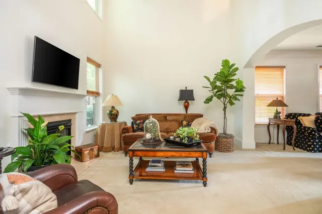 a living room with furniture fireplace and flat screen tv
