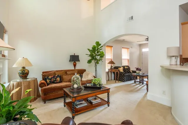 a living room with furniture and a chandelier