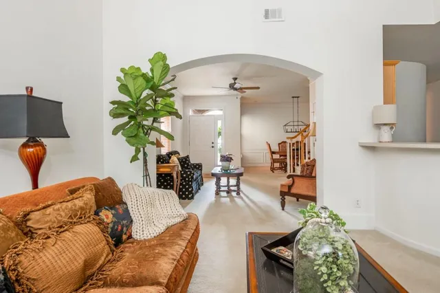 a living room with furniture and a chandelier