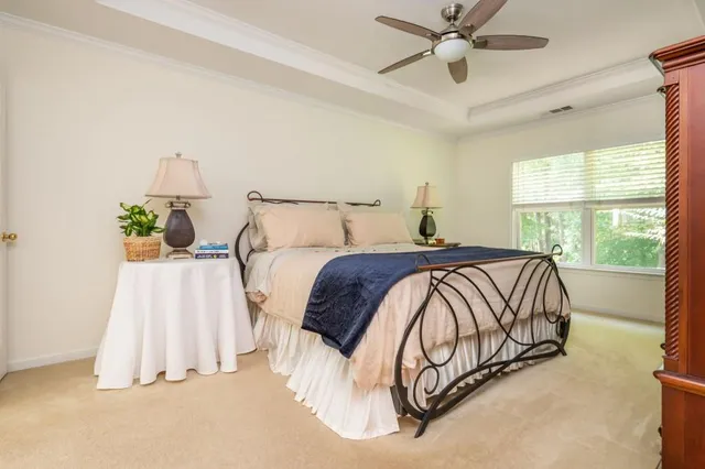 a bed sitting in a bedroom next to a window
