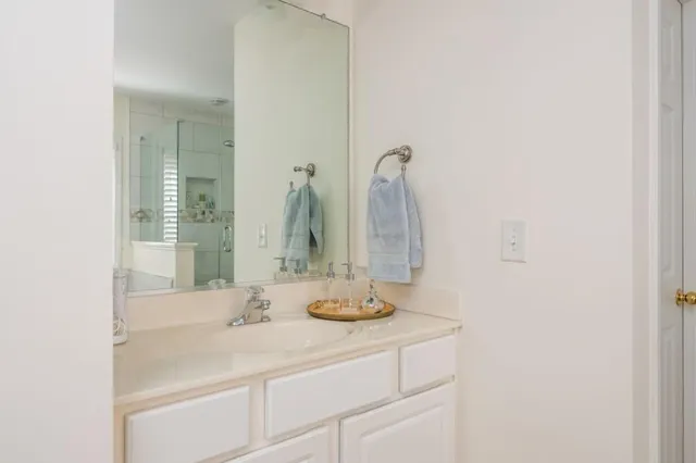 a bathroom with a shower and a sink