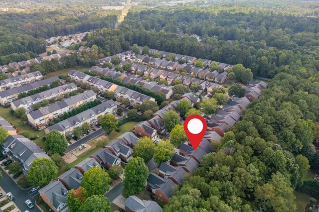 an aerial view of a house with a yard