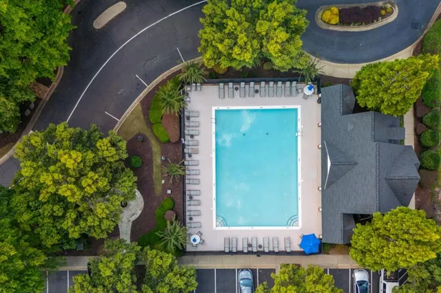 a house view with swimming pool and sitting area