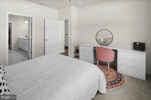 a bedroom with a bed and dresser