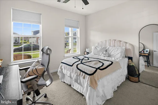 a bed room with a bed and a chair