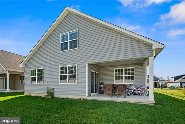 a front view of house with yard and outdoor seating