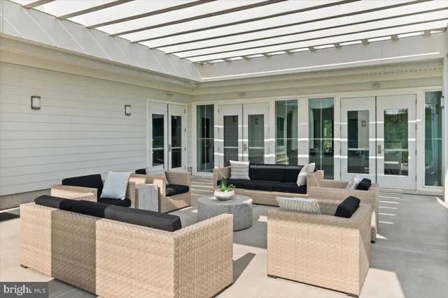 a living room with fireplace furniture and floor to ceiling windows