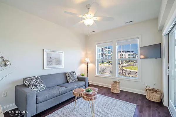 a living room with furniture and wooden floor