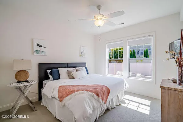 a bedroom with a bed mirror and window