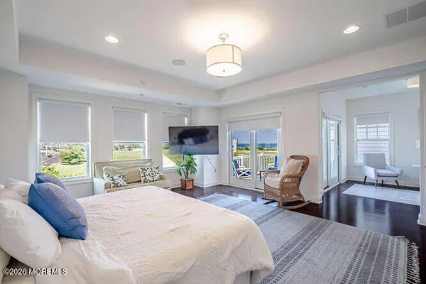 a dining room with furniture wooden floor and a chandelier