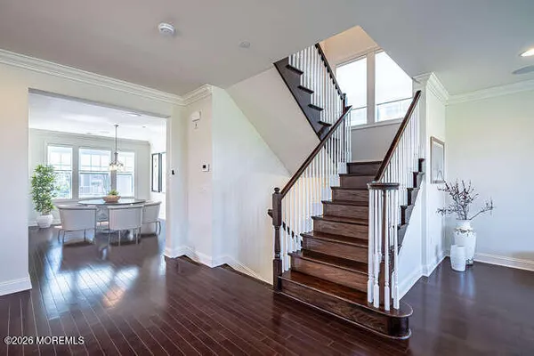 a view of entryway with wooden floor and stairs