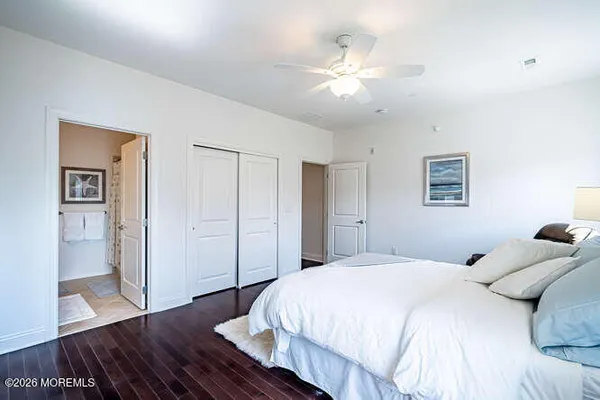 a spacious bathroom with a sink a toilet and a large mirror