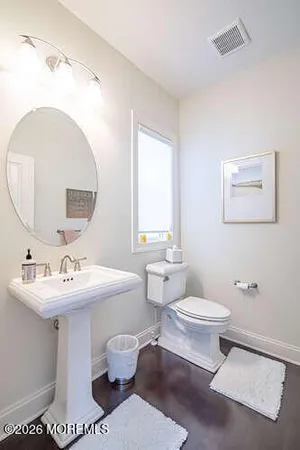 a bathroom with a sink toilet and mirror