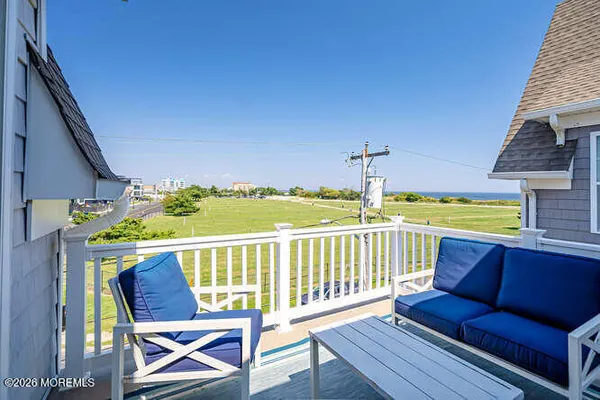 a view of a chair and table on the deck