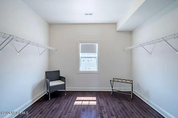 a view of room with window and wooden floor