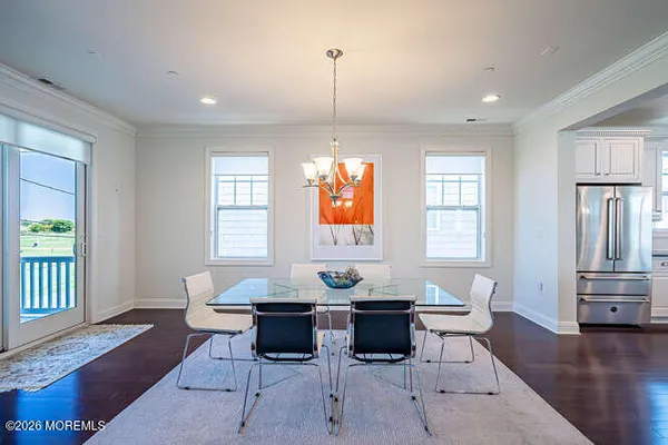 a living room with furniture a window and a dining table with wooden floor