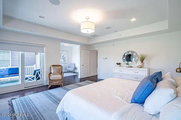 a bedroom with a bed couches chair and a window