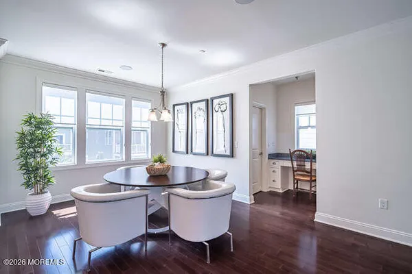 a dining room with furniture wooden floor and a chandelier