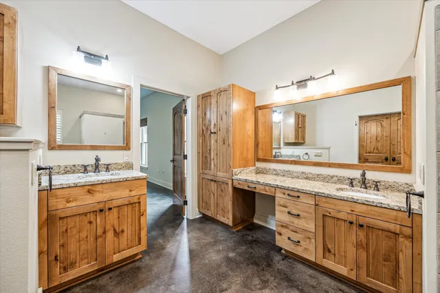 a spacious bathroom with a granite countertop sink mirror and a