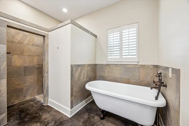 a bathroom with a tub and a shower