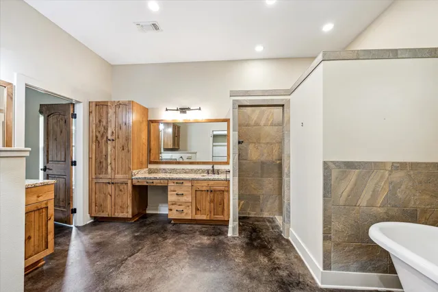 a view of kitchen with stainless steel appliances granite countertop a refrigerator and a stove top oven
