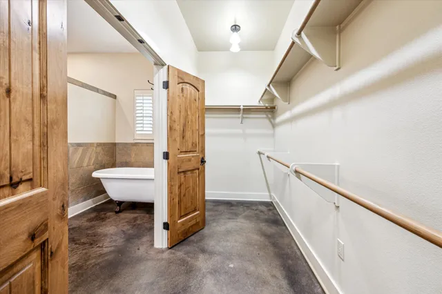 a view of entryway with a bathtub and door
