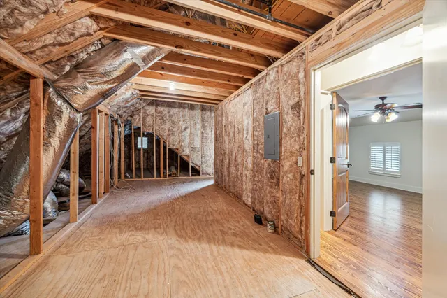 a view of a hallway with wooden floors and stairs