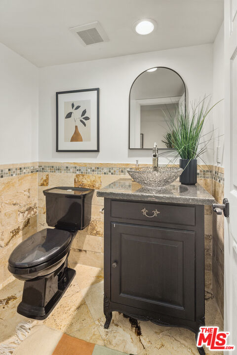 4549 Alla Road, Unit 5 Marina del Rey, CA 90292 - Photo 13 of 35 a bathroom with a granite countertop sink a toilet and mirror