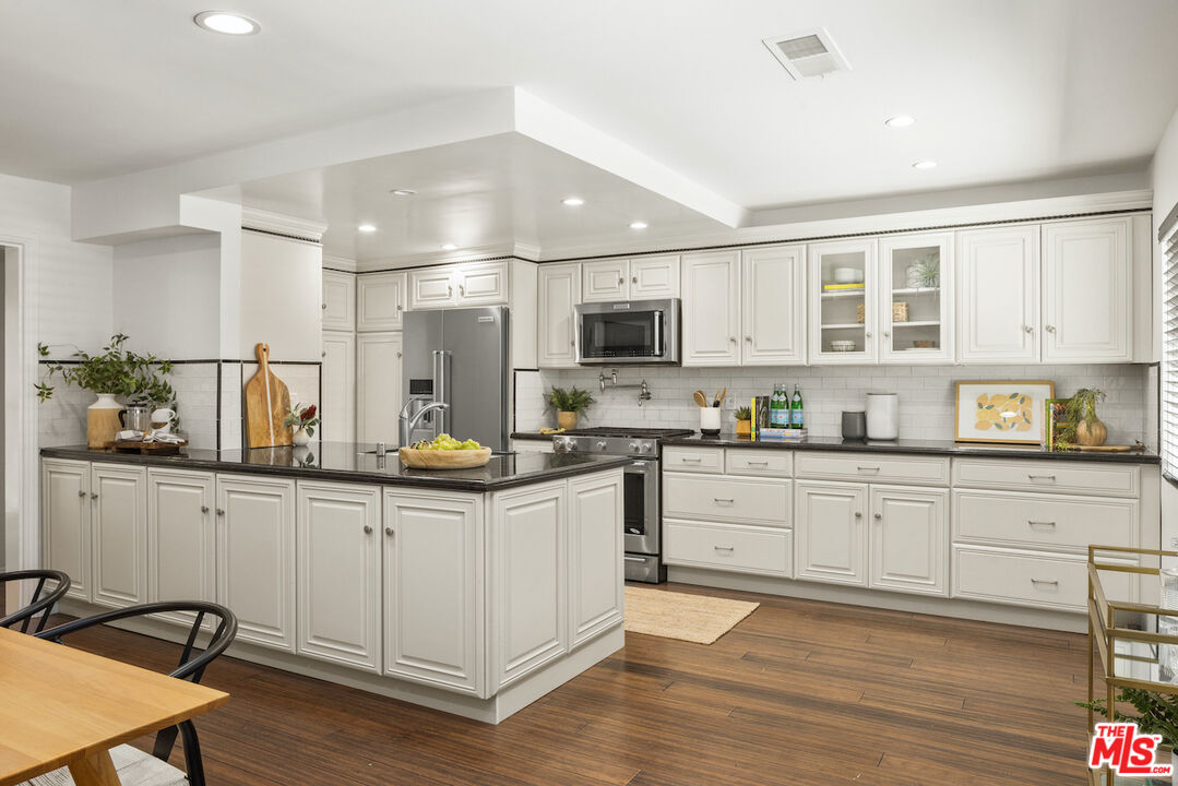 4549 Alla Road, Unit 5 Marina del Rey, CA 90292 - Photo 16 of 35 a kitchen with granite countertop white cabinets and white appliances