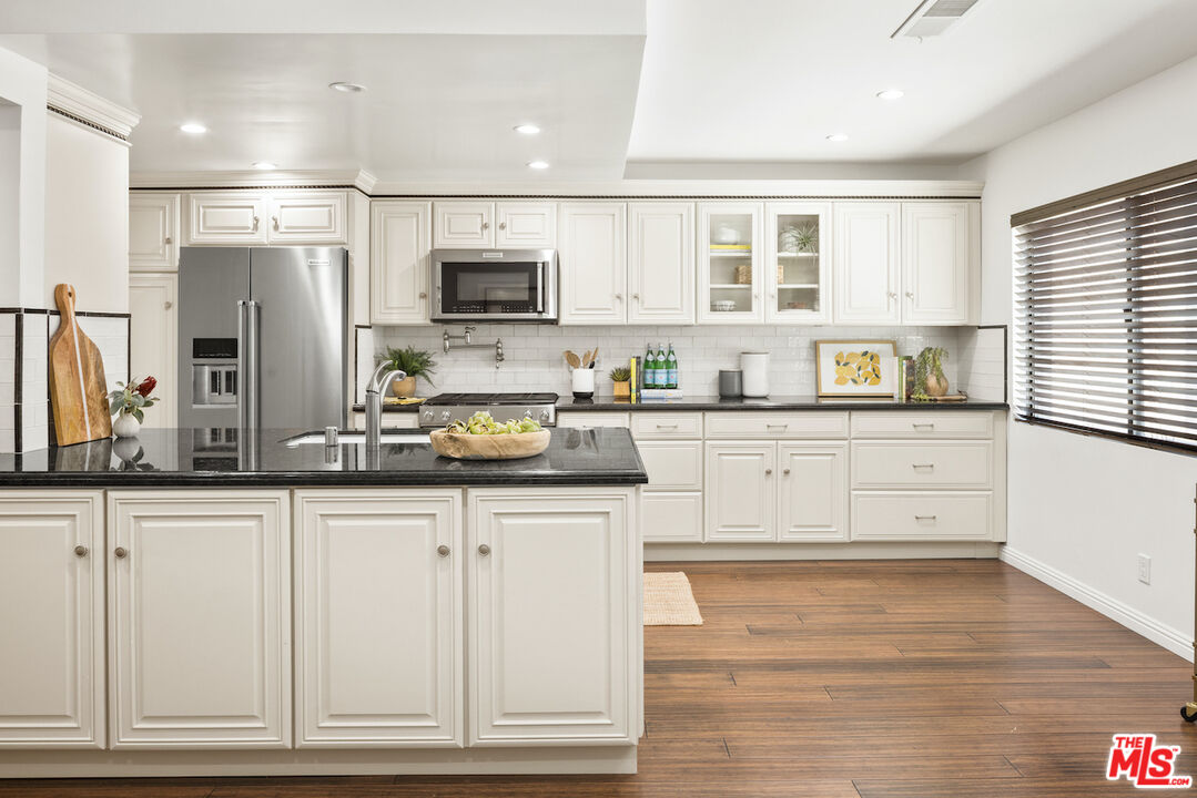 4549 Alla Road, Unit 5 Marina del Rey, CA 90292 - Photo 17 of 35 a kitchen with granite countertop white cabinets and stainless steel appliances