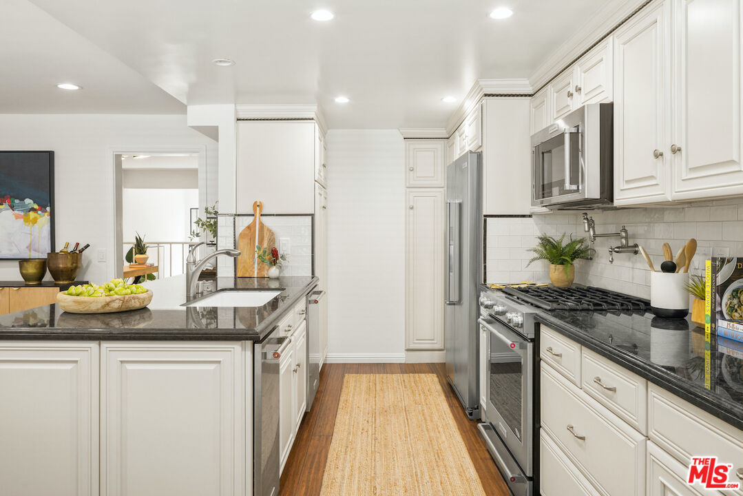 4549 Alla Road, Unit 5 Marina del Rey, CA 90292 - Photo 18 of 35 a kitchen with stainless steel appliances granite countertop a sink stove and refrigerator