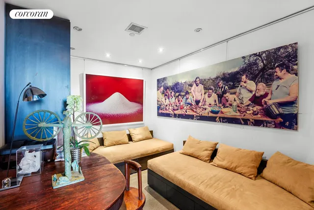 a living room with furniture cabinets and a window