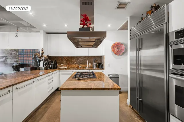 a large kitchen with a table and chairs