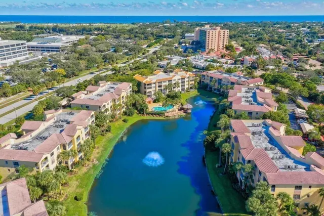 an aerial view of residential houses with outdoor space and swimming pool