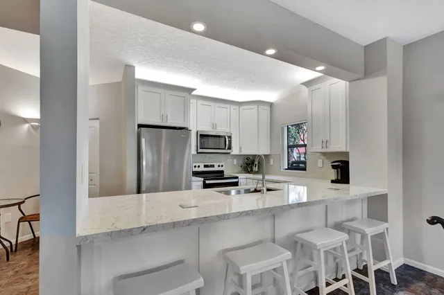 a dining room with furniture and a floor to ceiling window